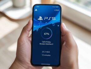 A close-up of a person holding a smartphone that displays the PlayStation 5 (PS5) app, clearly showing a game download in progress (67% complete), with the title "Call of Duty: Modern Warfare II," download speed, and estimated time remaining. This directly addresses the question, How to Check Download Progress on PS5 App.